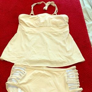 Cream tankini with gold embellishment at the neck
